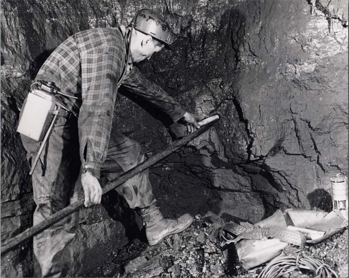 Black and WHite photo of a coal miner working