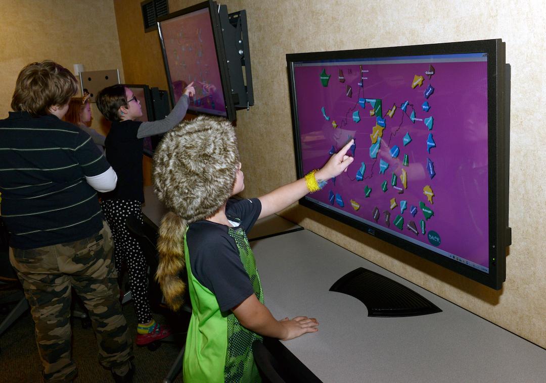 Kids at interactive touchscreens